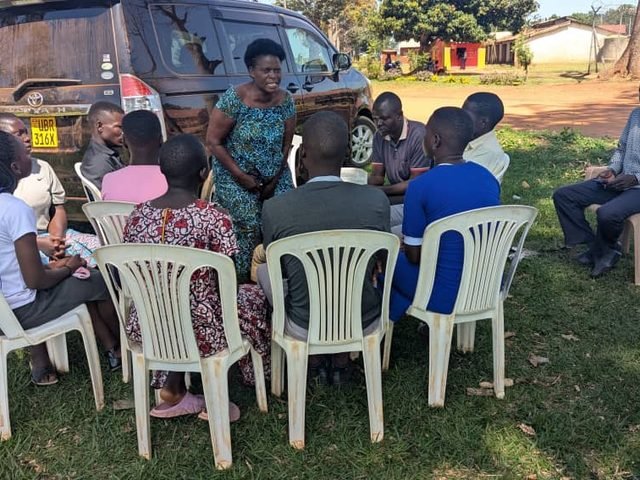 A counselling circle meeting beside a vehicle