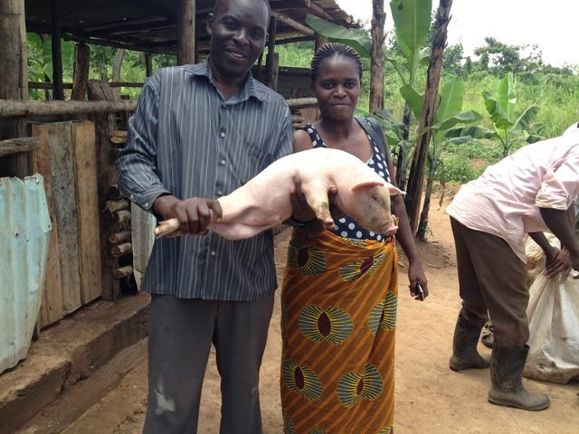 Two graduates of the piggery program