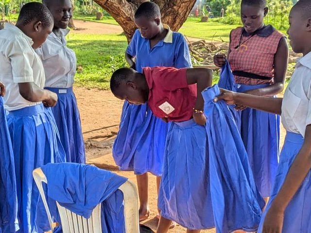 School girls receiving new uniforms