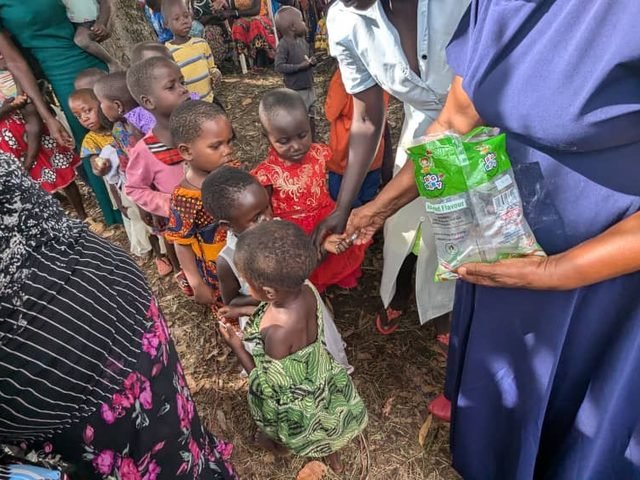 Children receiving snacks at an outreach event