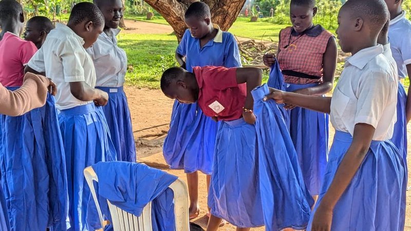 School girls we support, receiving school uniforms