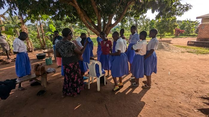 School girls we support, gathered together under a tree